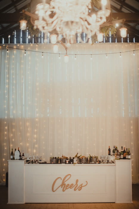 String lights behind sheer ivory draping. Draping and lighting by Draping by Kim